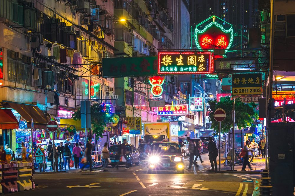 A busy street in Hong Kong at night.