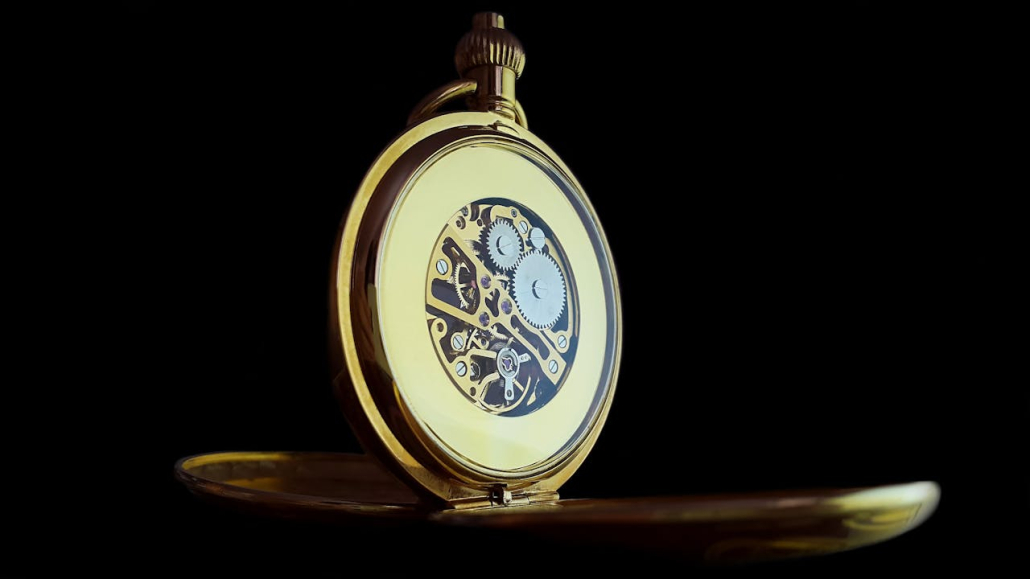 A close-up view of a gold pocket watch.